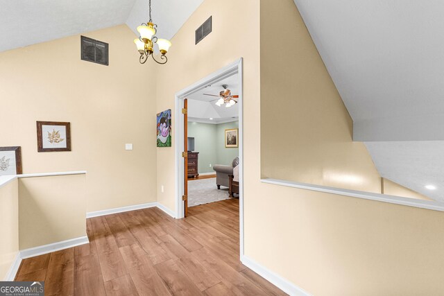 living room featuring vaulted ceiling, ceiling fan, a textured ceiling, and dark hardwood / wood-style flooring