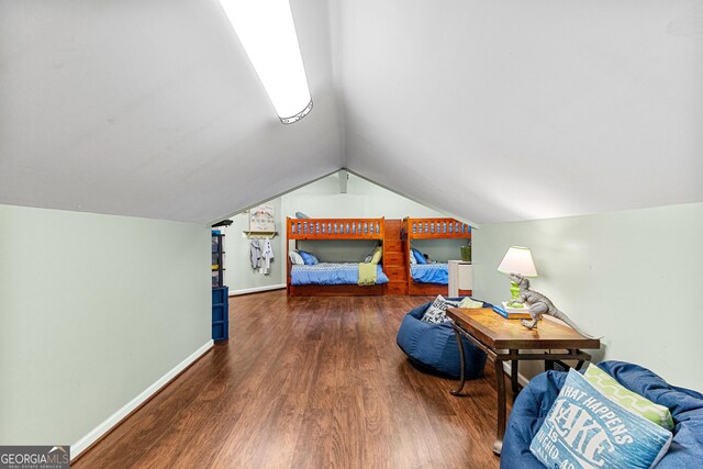 bedroom with lofted ceiling, a textured ceiling, and dark hardwood / wood-style flooring