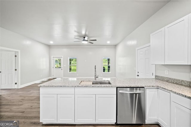 kitchen featuring white cabinetry, sink, stainless steel dishwasher, ceiling fan, and light stone counters