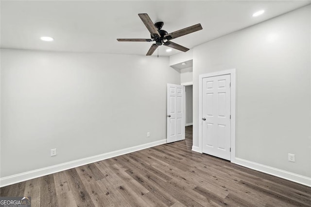 spare room featuring ceiling fan and dark hardwood / wood-style flooring