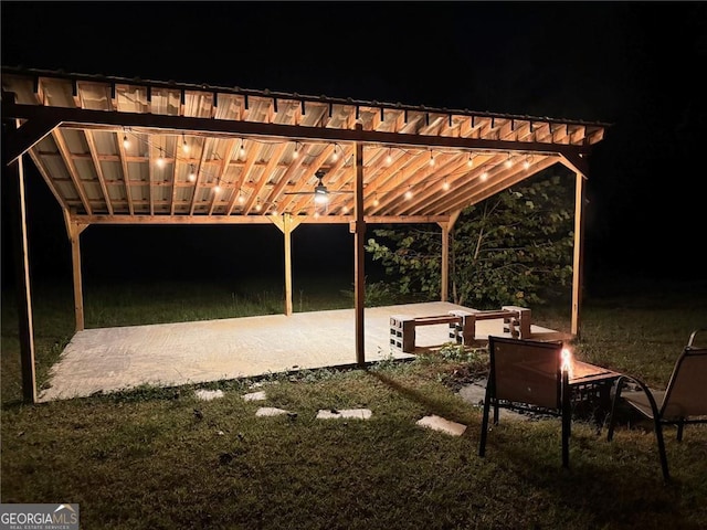 patio at night featuring a fire pit