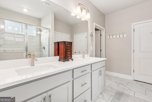 bathroom with vanity and a shower with shower door