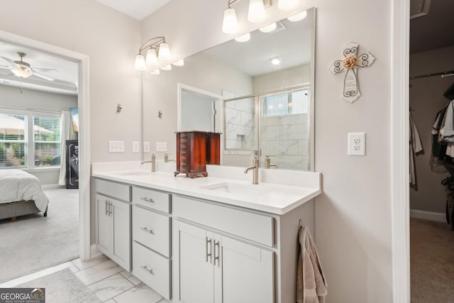 bathroom with vanity, ceiling fan, a healthy amount of sunlight, and walk in shower