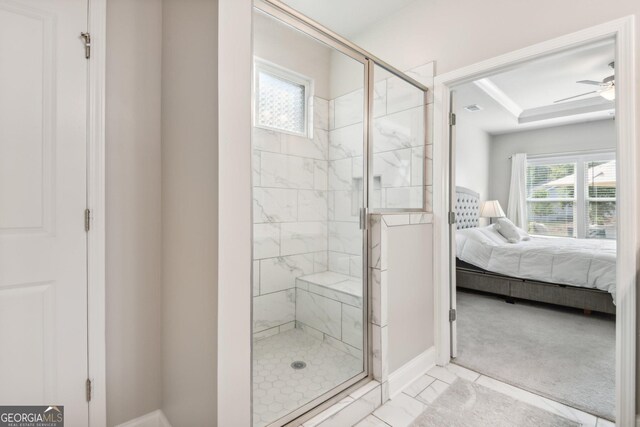 bathroom featuring a shower with door and ceiling fan