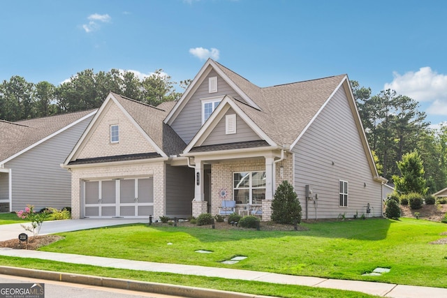 craftsman-style home featuring a porch, a garage, and a front yard