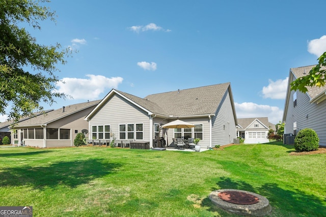 back of property featuring a yard, a patio area, central AC, and a sunroom