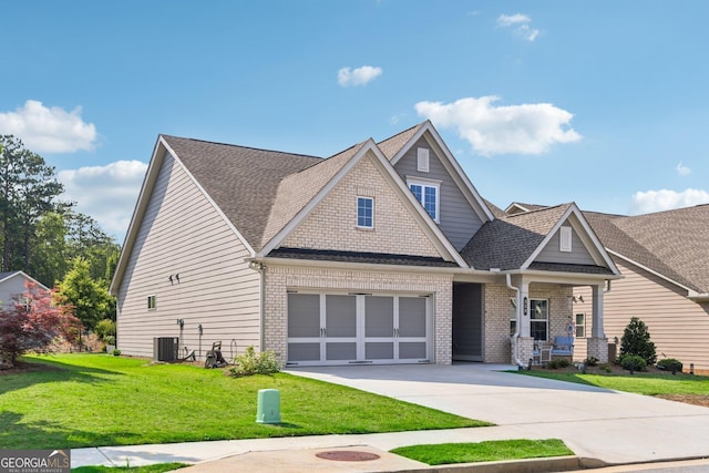 craftsman inspired home with a garage, a porch, central air condition unit, and a front lawn