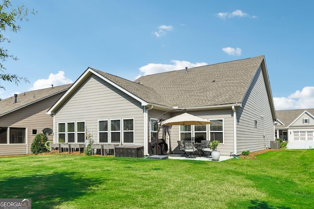 back of house featuring a patio, a lawn, and central air condition unit