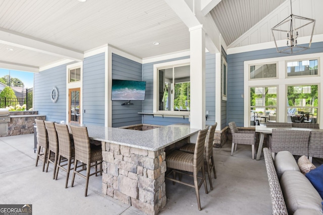 view of patio / terrace featuring an outdoor hangout area and exterior bar