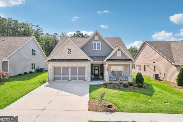 craftsman house with central AC and a front lawn