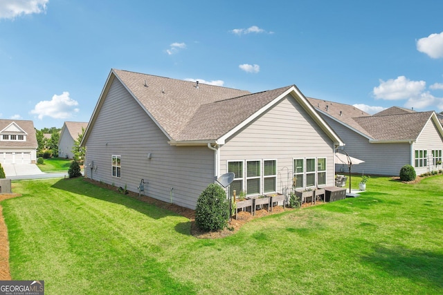 rear view of property with a lawn