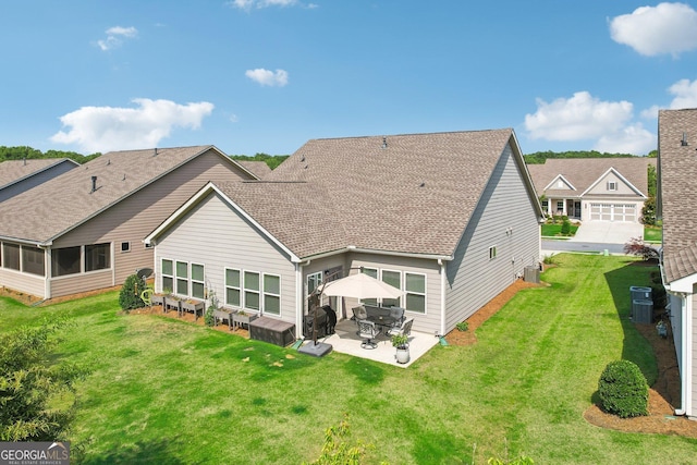 rear view of property featuring a yard and a patio area