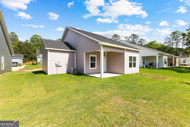 205 Lenox Cir, Lagrange, GA 30241 - back of property with a yard, a patio, central AC unit, and roof with shingles
