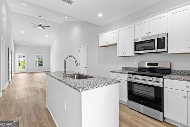 205 Lenox Cir, Lagrange, GA 30241 - kitchen with a sink, stainless steel dishwasher, dark wood-style floors, and white cabinetry