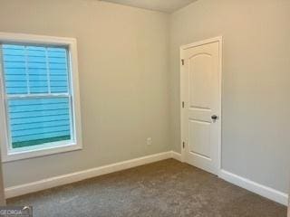 empty room with dark carpet