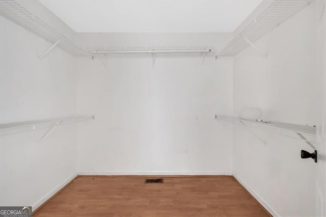 walk in closet featuring hardwood / wood-style flooring