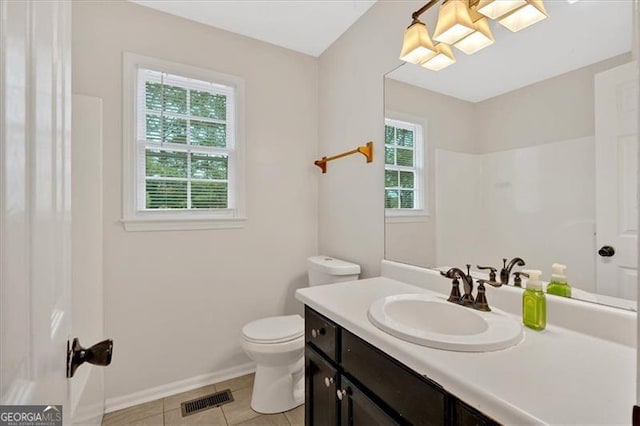 bathroom featuring toilet, visible vents, a wealth of natural light, and tile patterned floors