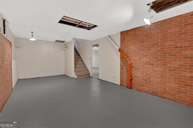 basement featuring brick wall