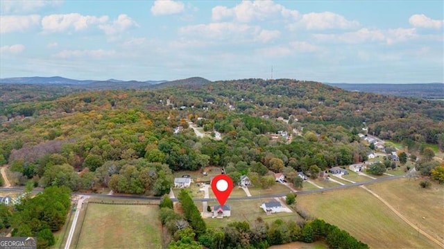 birds eye view of property featuring a mountain view and a view of trees