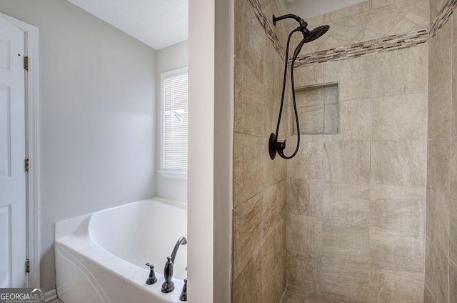 full bathroom featuring a garden tub and a tile shower