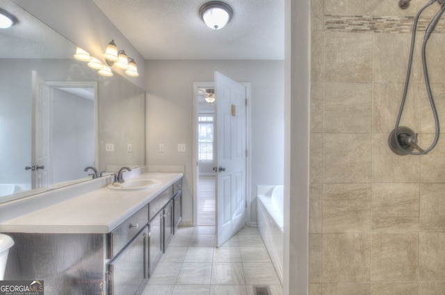 full bathroom with a bath, tiled shower, a textured ceiling, and vanity