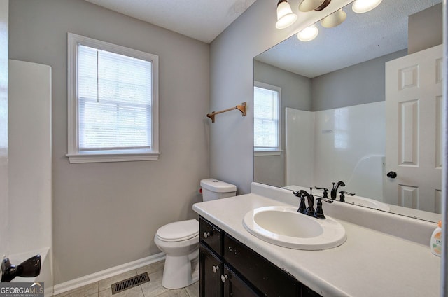 bathroom featuring visible vents, baseboards, toilet, tile patterned floors, and vanity