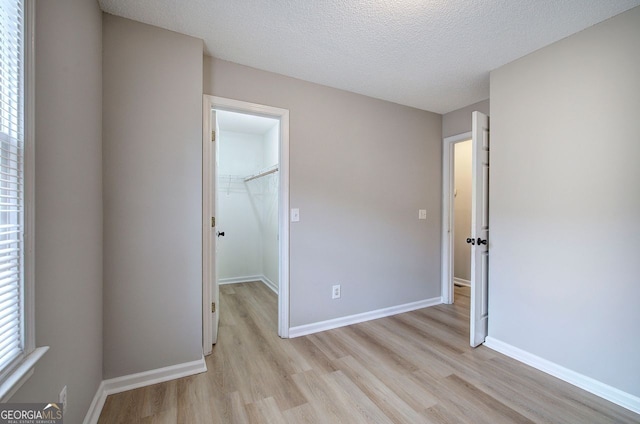 unfurnished bedroom with light wood-type flooring and baseboards