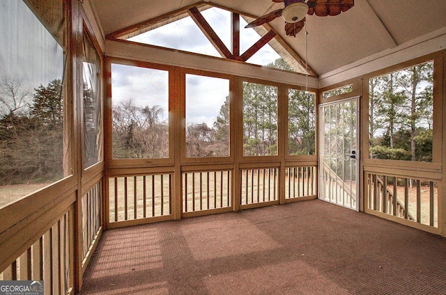 unfurnished sunroom featuring a ceiling fan and lofted ceiling