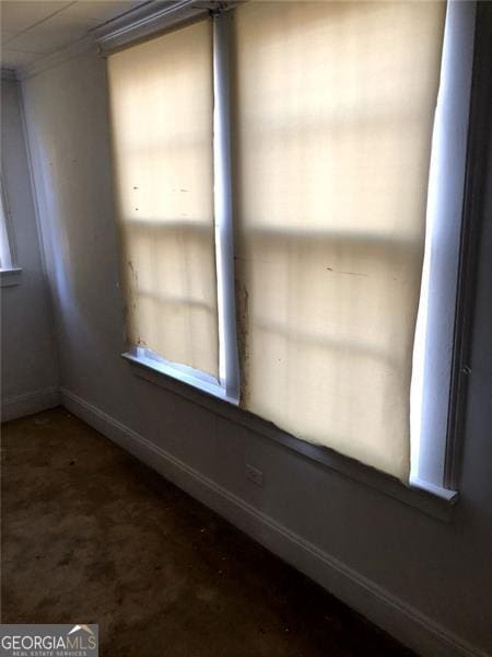 unfurnished room with crown molding