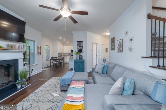 living room featuring ornamental molding, dark hardwood / wood-style floors, and ceiling fan