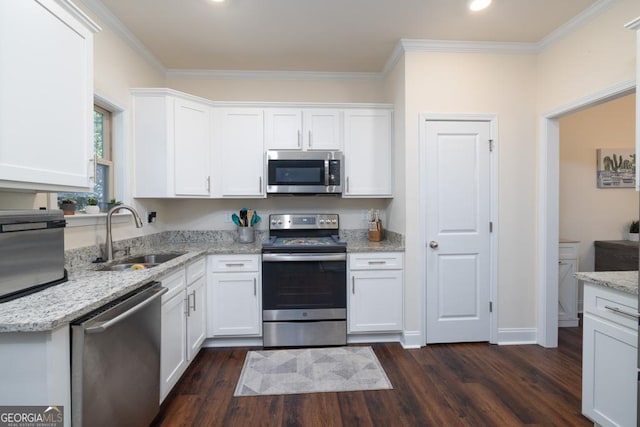 kitchen with appliances with stainless steel finishes, sink, and white cabinets