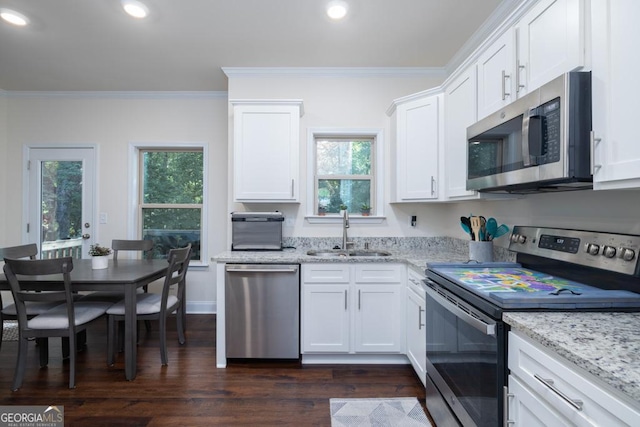 kitchen featuring crown molding, appliances with stainless steel finishes, sink, and white cabinets