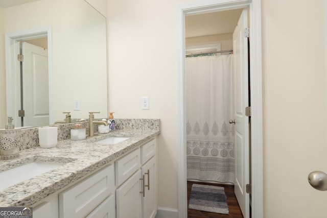 bathroom featuring walk in shower and vanity