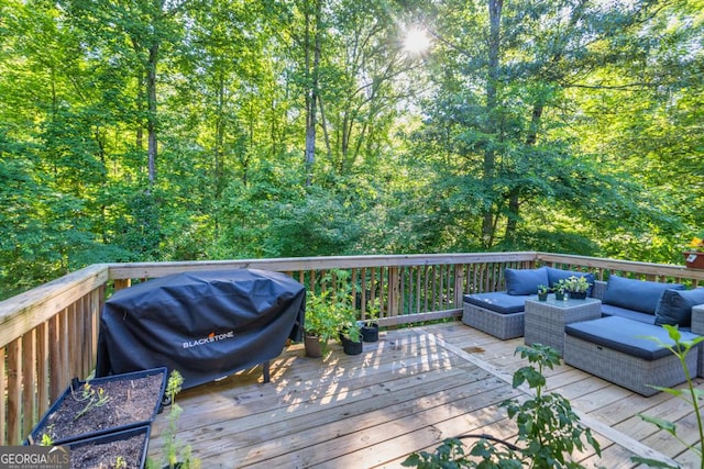 deck with a grill and an outdoor hangout area