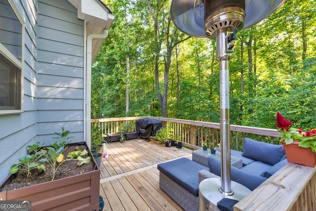 wooden terrace with outdoor lounge area and a grill