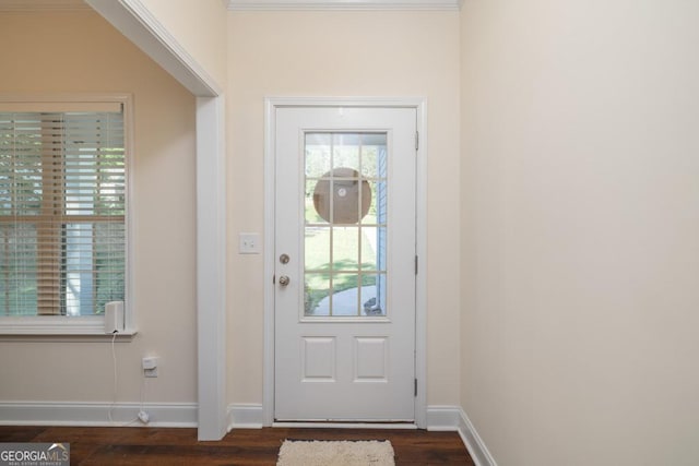 entryway featuring crown molding and dark hardwood / wood-style flooring