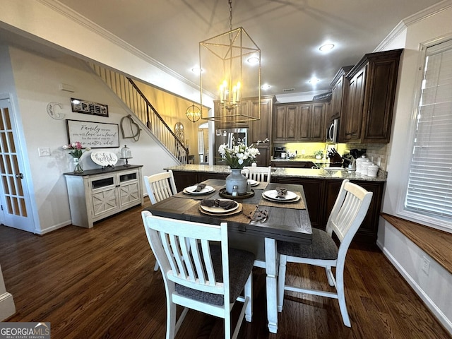 dining room with ornamental molding, dark wood-type flooring, and a chandelier