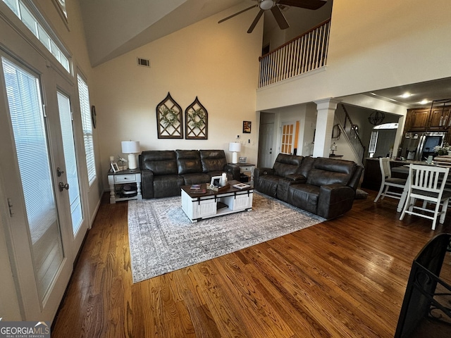 living room with french doors, ceiling fan, dark hardwood / wood-style flooring, and ornate columns