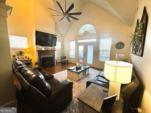 living room featuring ceiling fan, high vaulted ceiling, light hardwood / wood-style floors, and french doors