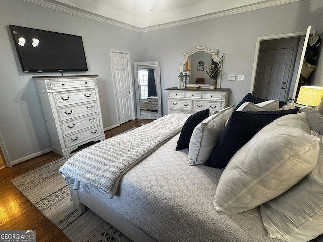 bedroom featuring ornamental molding and dark hardwood / wood-style floors