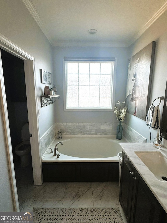 bathroom with ornamental molding, a bathing tub, vanity, and toilet