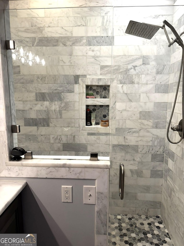 bathroom featuring an enclosed shower and vanity