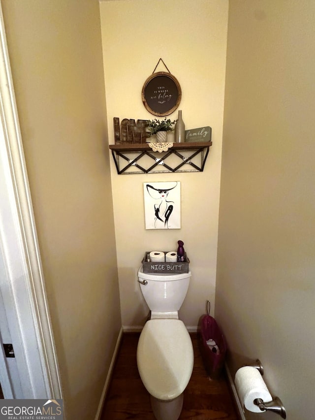 bathroom featuring wood-type flooring and toilet