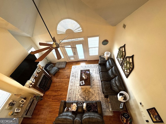 living room featuring ceiling fan, dark wood-type flooring, and high vaulted ceiling