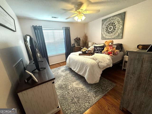 bedroom featuring ceiling fan and dark hardwood / wood-style flooring