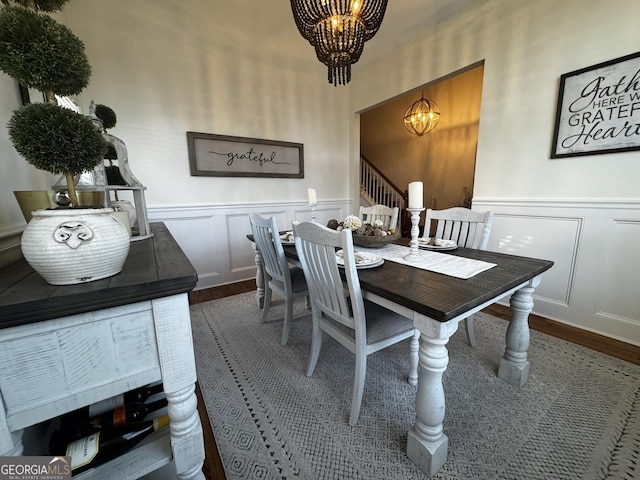 dining area featuring dark hardwood / wood-style floors and a chandelier