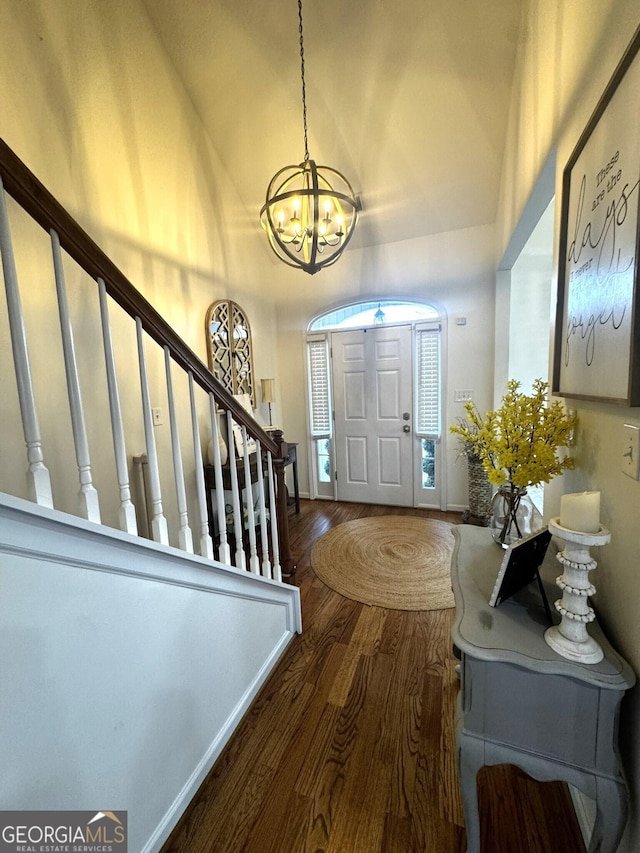 foyer featuring an inviting chandelier and dark hardwood / wood-style floors