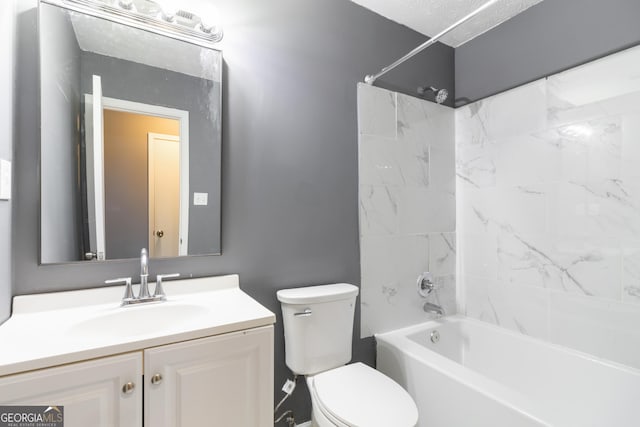 full bathroom featuring tiled shower / bath combo, vanity, and toilet