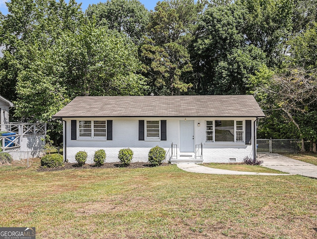 single story home featuring a front lawn, crawl space, fence, and brick siding