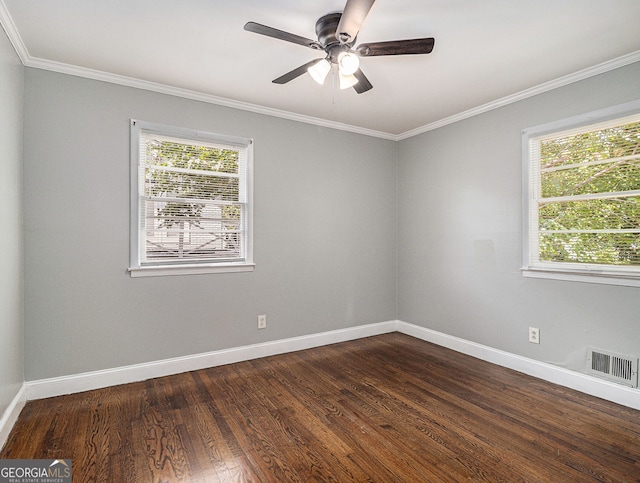 empty room with baseboards, plenty of natural light, visible vents, and dark wood-type flooring